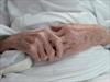 An elderly patient's hands at a hospital