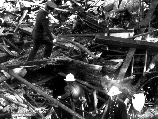 Firemen sift through remains of Ghost Train ride at Luna Park. Picture: Uwe Kuessner