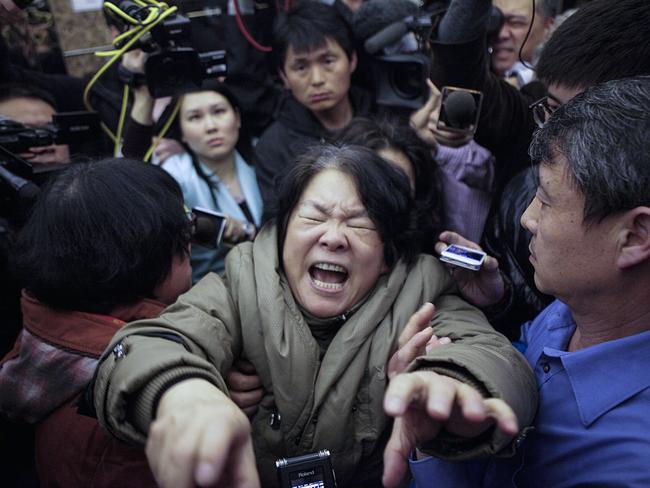 A family member of a passenger from the missing Malaysia Airlines flight MH370 reacts in 2014. Picture: Getty Images