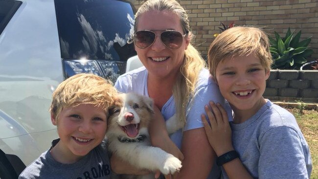 Kristy Durman and her two sons with their dog, Bowie, who was stolen from their Southport property during a break-in on Wednesday.