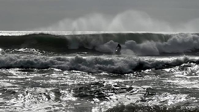 A wave rider takes on the bigger than usual surf near Mudjimba. Picture: Mark Furler