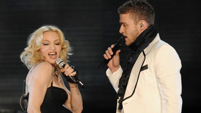 Madonna, left, is joined by Justin Timberlake for a duet during her performance to celebrate the release of her new CD 'Hard Candy' at Roseland Ballroom, Wednesday, April 30, 2008 in New York. (AP Photo/Evan Agostini)