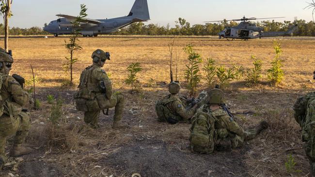 Soldiers from the 5th Battalion, the Royal Australian Regiment watch on as United States Marine Corps aircraft prepare to depart the airstrip at Mount Bundey Training Area in the Northern Territory.