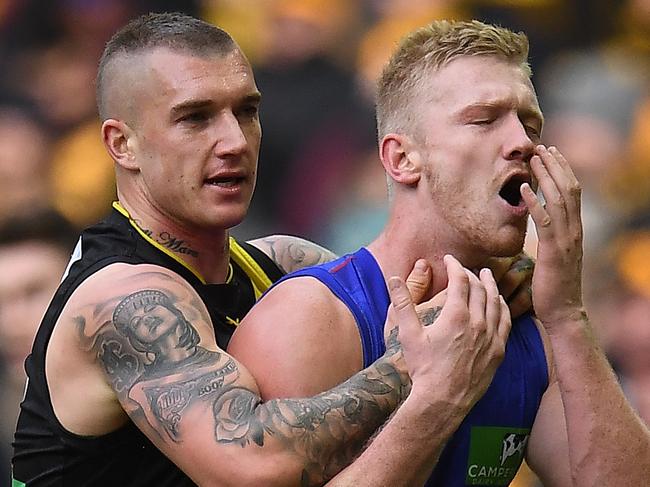 Dustin Martin of the Tigers (left) and Nick Robertson of the Lions clash during the Round 17 AFL match between the Richmond Tigers and the Brisbane Lions at Etihad Stadium in Melbourne, Sunday, July 16, 2017. (AAP Image/Julian Smith) NO ARCHIVING, EDITORIAL USE ONLY