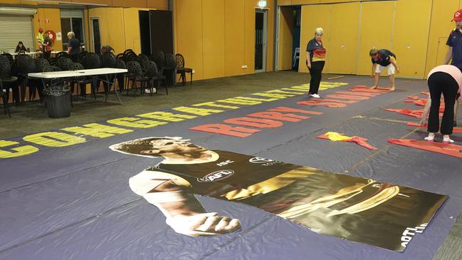 The Crows supporters group makes the banner for Rory Sloane’s 200th game which they don’t know when they’ll be able to hold. Pictures: Supplied.