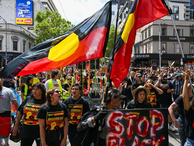 MELBOURNE, AUSTRALIA - JANUARY 26: Protesters march from Parliament House to Flinder's Street Station during  the Treaty Before Voice Invasion Day Protest  on January 26, 2023 in Melbourne, Australia.  Australia Day, formerly known as Foundation Day, is the official national day of Australia and is celebrated annually on January 26 to commemorate the arrival of the First Fleet to Sydney in 1788. Many indigenous Australians refer to the day as 'Invasion Day' and there is a growing movement to change the date to one which can be celebrated by all Australians. (Photo by Alexi J. Rosenfeld/Getty Images)