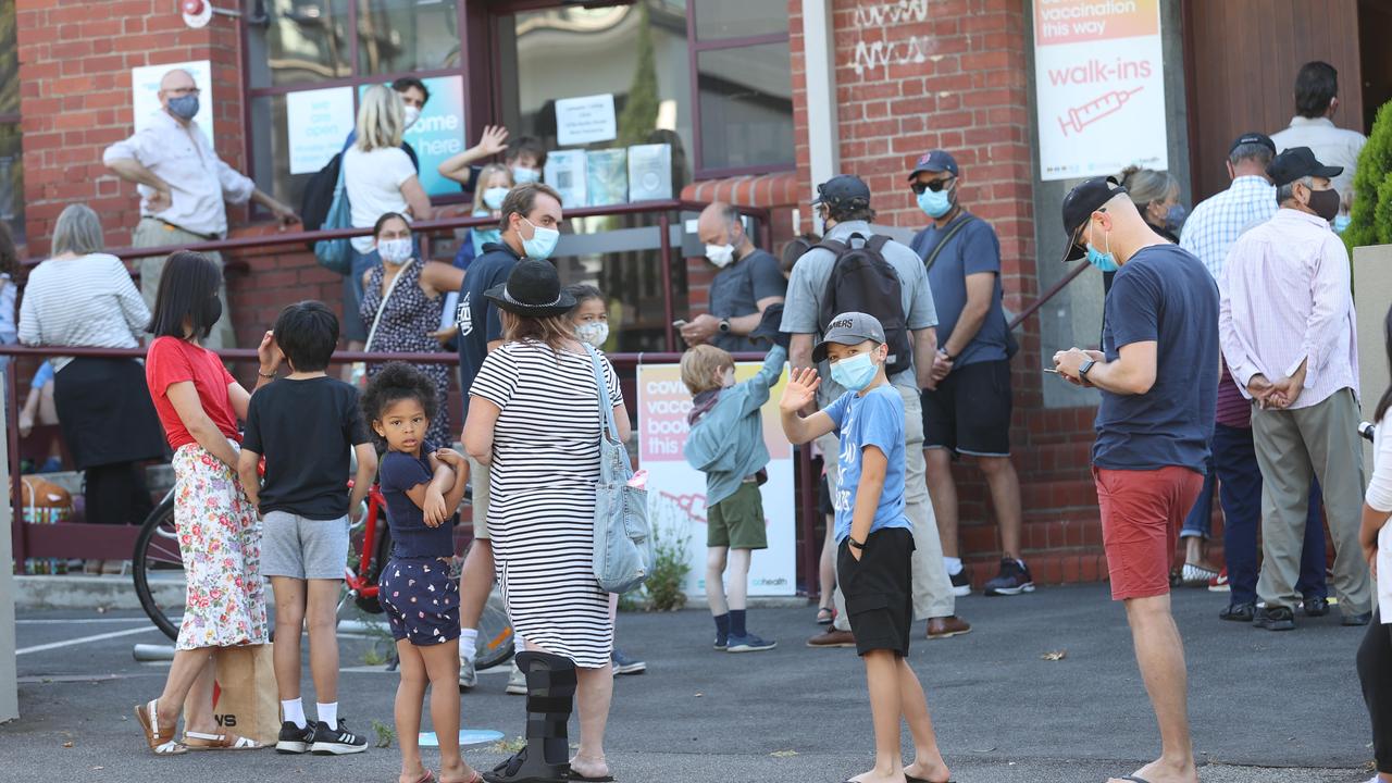 Families lining up at a West Melbourne vaccination clinic. Picture: David Caird