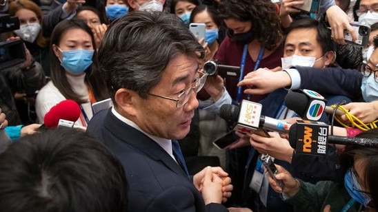 Dr George Gao surrounded by a press pack. Picture: AP