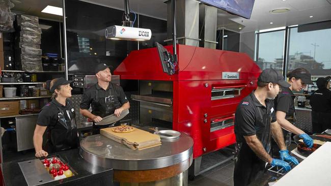 Dominos CEO Nick Knight and the new high-tech Pizza Checker. Picture: Supplied