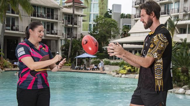 Manunda Hawks co-coach Kareena White passes to North Cairns Tigers coach Jason Tom at the AFL Cairns fixture launch. Picture: Brian Cassey