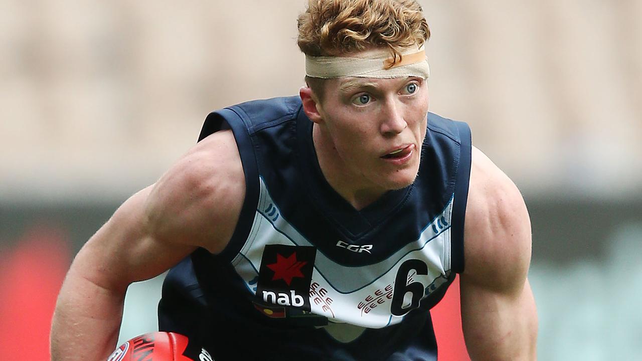 A bandaged Matthew Rowell runs with the ball. Pic: Getty Images