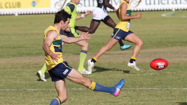 Eagle Chris Hall propels the ball forward in his 150th SANFL game at Woodville yesterday. Picture: Russell Millard (AAP).