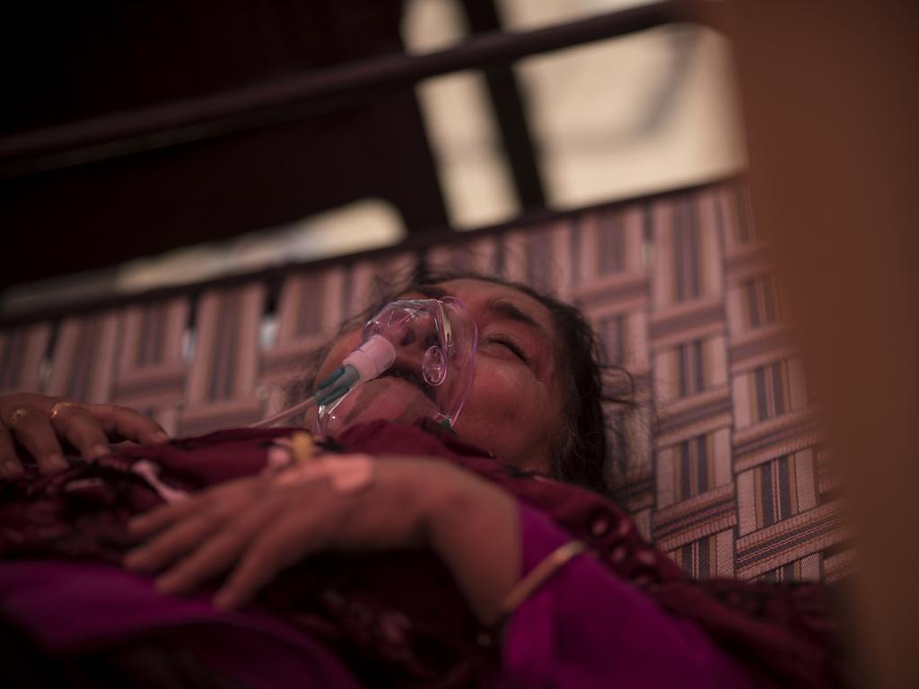 A woman wears an oxygen mask in New Delhi, India, which has been unable to keep up with the demand for oxygen for people with COVID-19. Picture: Anindito Mukherjee/Getty Images