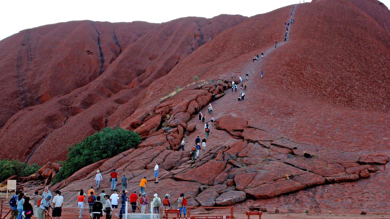 Although it’s against the wishes of the traditional owners, tourists still climb Uluru. Picture: AAP Image/Terry Trewin