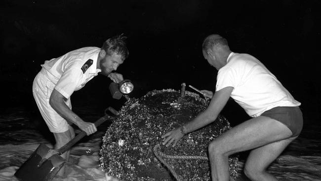Lieutenant T. Parker and Chief Petty Officer T. Dollar, of the Navy's Mine Clearance team, attempted to prepare a stranded mine at Surfers Paradise for demolition.