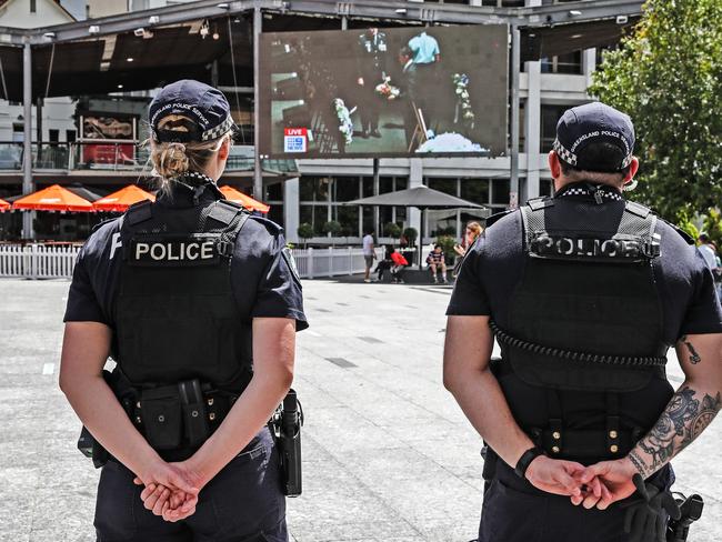 Members of the Queensland police service watch the Queensland Police Memorial Service for Constable Rachel McCrow and Constable Matthew Arnold from King George Square. Picture: Zak Simmonds