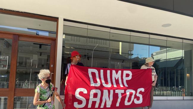 Protestors held "DUMP SANTOS" signs outside the Santos building. Picture: Isabel McMillan