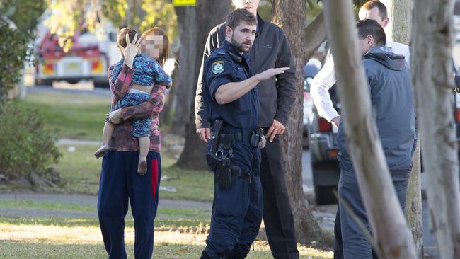 A woman believed to be a bystander comforts the child taken on the pursuit in his father’s vehicle.