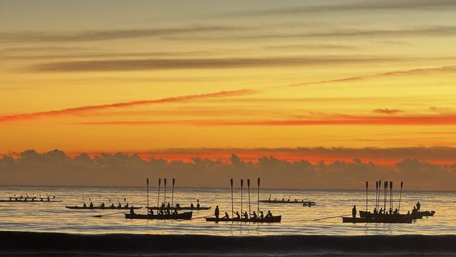 Mooloolaba surf boats in a raised oar salute as part of the dawn service at Anzac Day 2024 at Mooloolaba which was attended by about 5000 people. Photo: Mark Furler