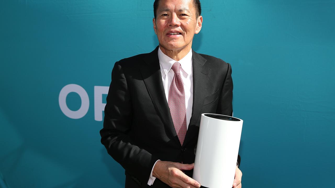 Optus chief executive officer Allen Lew holds one of the company’s 5G wireless modems.