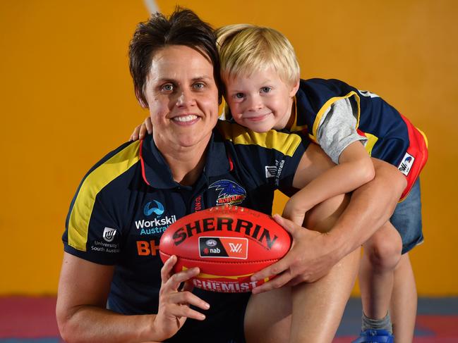 Courtney Gum with her son Buz - 5yrs pose for a photograph at the Crows HQ in West Lakes, Adelaide on Thursday the 20th of February 2020. Courtney seriously thought about retiring from AFLW this season now she is literally flying having been nominated for the mark of the year award. (AAP/ Keryn Stevens)