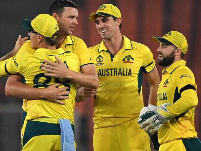 Australia's captain Pat Cummins (2R) celebrates with teammates after their win at the end of the 2023 ICC Men's Cricket World Cup one-day international (ODI) match against England at the Narendra Modi Stadium in Ahmedabad on November 4, 2023. (Photo by Money SHARMA / AFP) / -- IMAGE RESTRICTED TO EDITORIAL USE - STRICTLY NO COMMERCIAL USE --