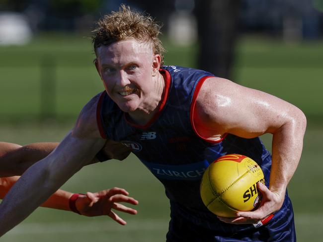 MELBOURNE , AUSTRALIA.February 12 , 2024.  Melbourne AFL football training at Goschs Paddock. Clayton Oliver of the Demons  fends off Koltyn Tholstrup  . Pic: Michael Klein