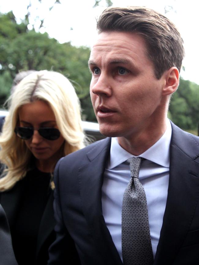 Oliver Curtis, pictured with wife Roxy Jacenko at court, has swapped his designer suit for prison greens at Cooma Prison. Picture: News Corp