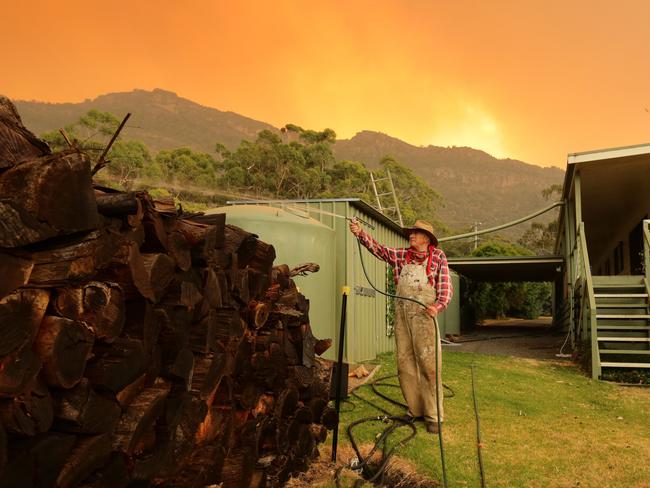 A Grampians local defends his property against a bushfire. There are fears newbies to the area may not have the same know how.