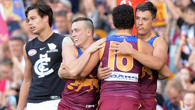 A dejected Jack Silvagni as Brisbane players celebrate.