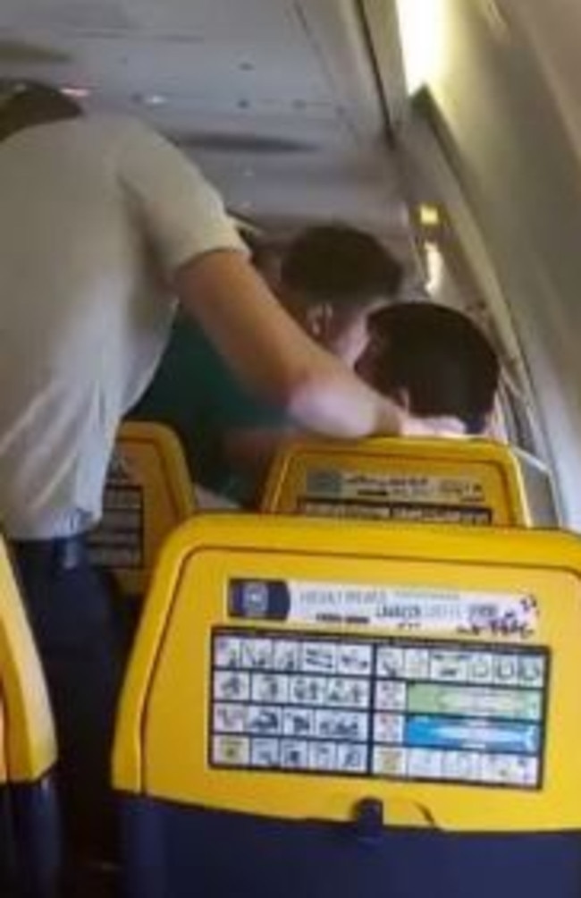 Passengers tried to calm him before pinning him down.