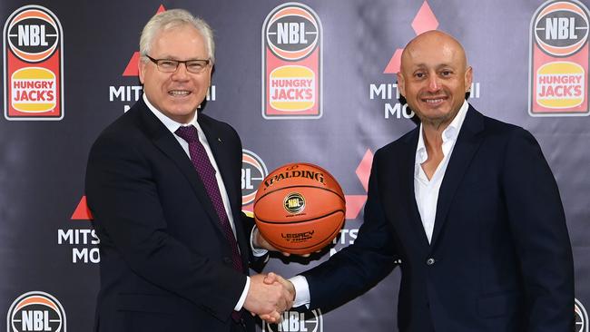 Mitsubishi CEO Shaun Westcott shakes hands with Larry Kestelman of the NBL. Photo by Quinn Rooney/Getty Images for NBL