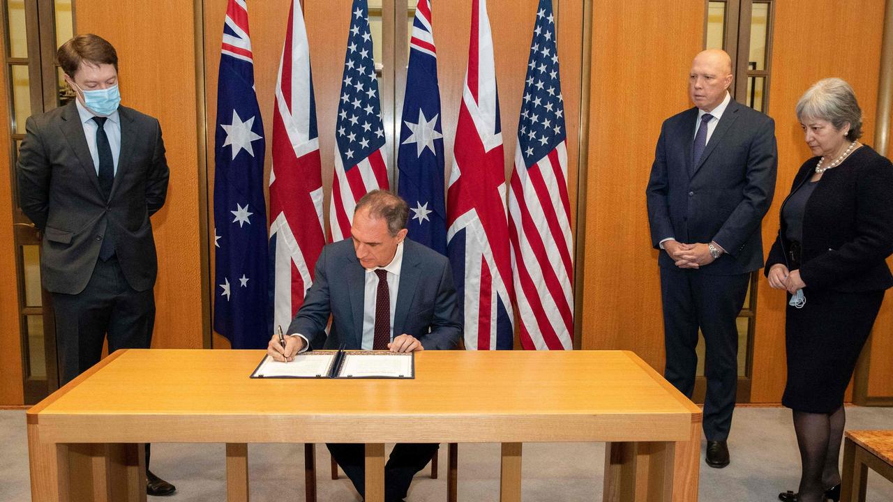 Michael Goldman (2nd L) signing the Exchange of Naval Nuclear Propulsion Information Agreement as Australia's Minister for Defence Peter Dutton (2nd R) and British High Commissioner Victoria Treadell (R) look on. Picture: Kym Smith / Australian Defence Force / AFP