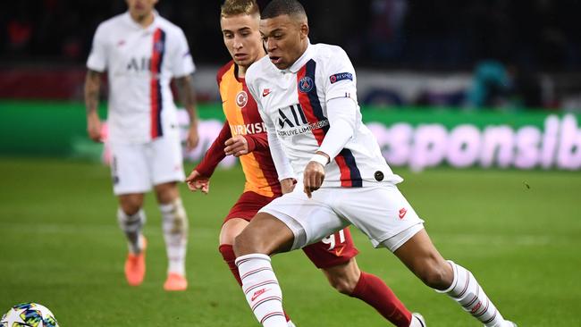 Kylian Mbappe glides past Galatsaray’s Emre Mor in the Champions League.