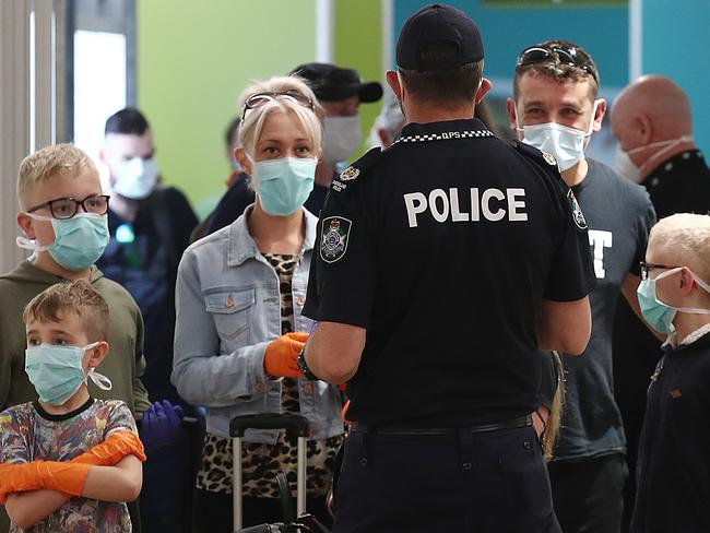 The Queensland Government has declared Adelaide a COVID hotspot, after 17 confirmed cases of coronavirus were declared in the South Australian capital. Queensland Police register the details of all passengers arriving from Adelaide at Cairns Airport, less than 24 hours before a mandatory quarantine for passengers comes into effect. Picture: Brendan Radke