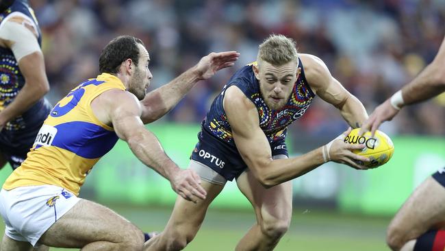 Adelaide’s Hugh Greenwood evades from West Coast’s Shannon Hurn. Picture SARAH REED.