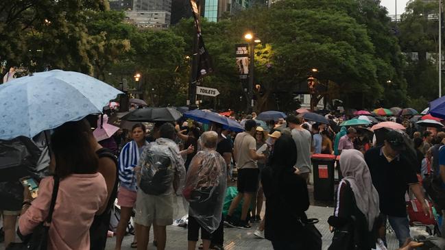 Revellers on Sydney Harbour foreshore as a storm hits. Picture: Adella Beaini