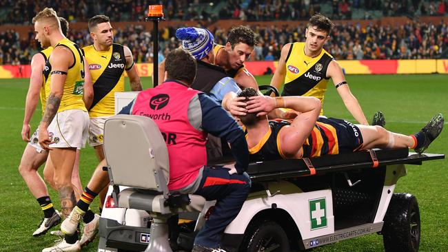 Richmond players wish injured Josh Jenkins of the Adelaide Crows all the best.