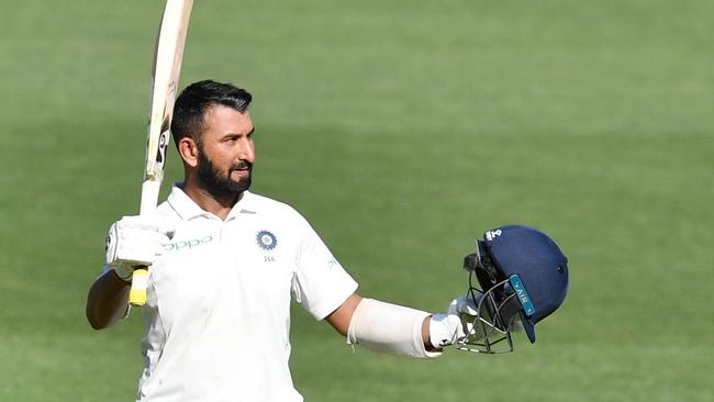 Indian batsman Cheteshwar Pujara celebrates bringing up his century at Adelaide Oval on Thursday. Picture: AAP