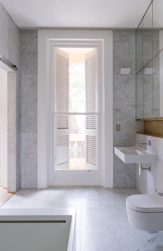 <b>AFTER: </b>Marble gives a seamless feel in the bathroom and a brass recess was used to break up the white.