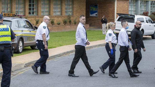 Thomas Nichols and Thomas Pinnington walk with guards during a court viewing of the scene at Adelaide High School. Picture: NCA NewsWire