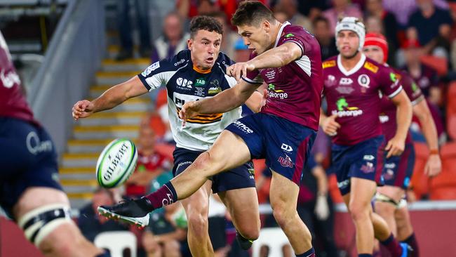 The Reds' James O'Connor kicks the ball as he is tackled by the Brumbies' Tom Banks during the Super Rugby AU final between the Queensland Reds and ACT Brumbies at Suncorp Stadium in Brisbane on Saturday. Picture: Patrick Hamilton/AFP