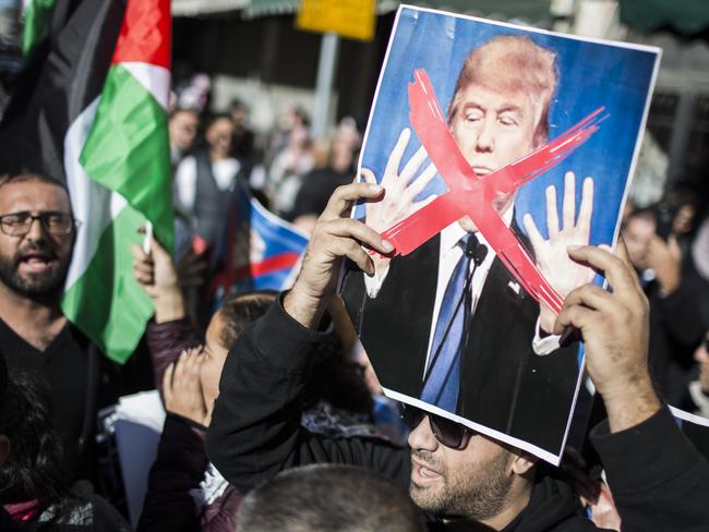 JERUSALEM, ISRAEL - DECEMBER 09:  Palestinian hold portrait of Donald Trump during protest on December 9, 2017 in Jerusalem, Israel. Protest in Jerusalem, West Bank and Gaza continue into the fourth day following U.S. President Donald Trump's decision to recognize Jerusalem as Israel's capital..  (Photo by Ilia Yefimovich/Getty Images)