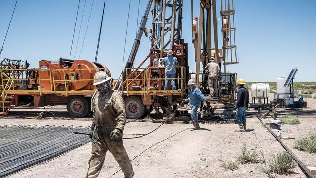 Workers cap off an oil well on the outskirts of Pecos, Texas, May 22, 2020. Picture: Cengiz Yar