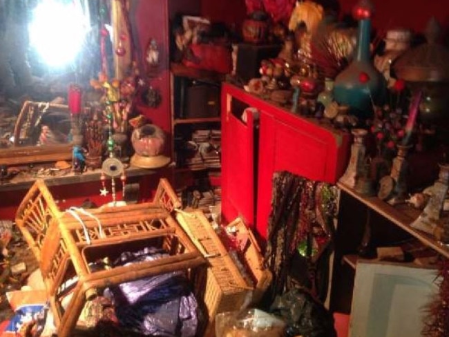 Furniture, trinkets and clothing fill the rooms of the former hoarder’s home.