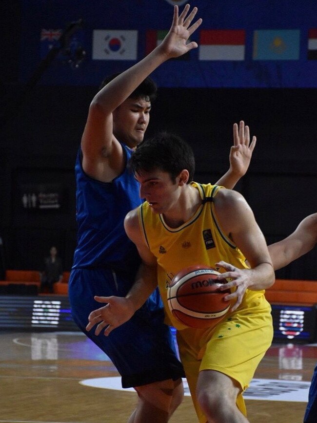 Callum Dalton driving into the basket against Thailand at the Under 19 Asia Cup.