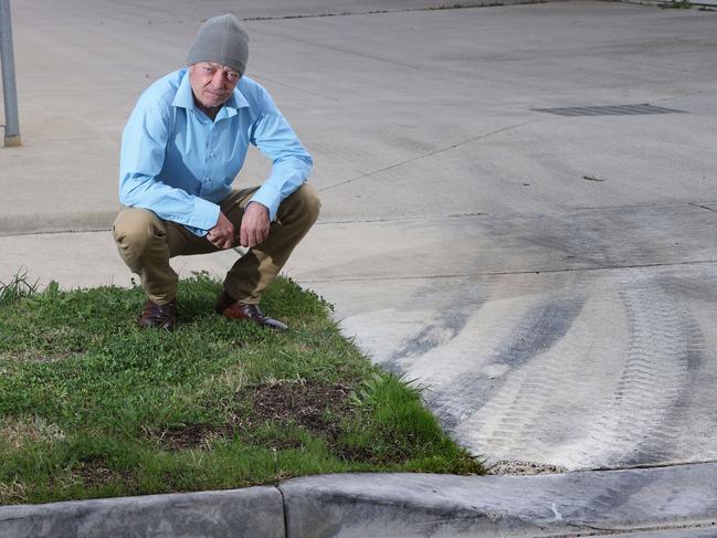 Shane Allaway and the skid marks left by rubbish truck drivers. Picture: Alison Wynd