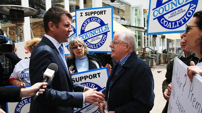 The premier was met with opposition to council amalgamations at a recent event in Manly. Picture: Toby Zerna.