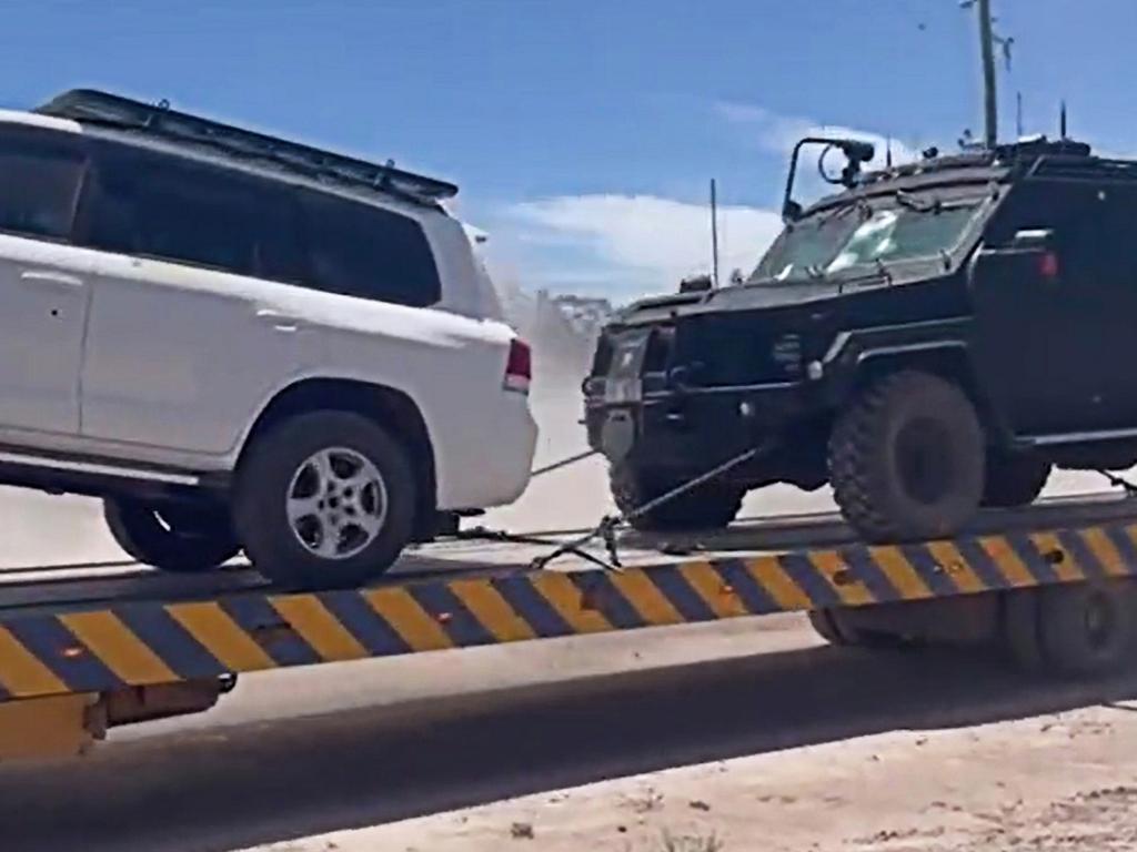 Bullet-ridden police car and BearCat armoured truck used by SERT being towed from the scene of the shooting in Wieambilla. Source: Channel 10