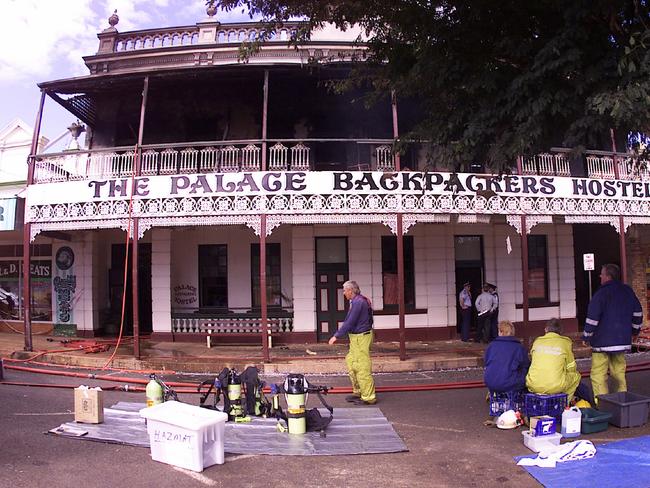 Police and SES officers outside Palace Backpackers Hostel in Childers after the fire that killed 15 people. Pic Anthony Weate.